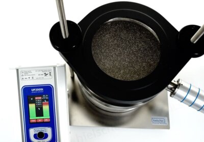 Ultrasonic sieve shaker with sieving tower for powder screening. Ultrasonic vibrations agitate the sieves for efficient screening of powders.