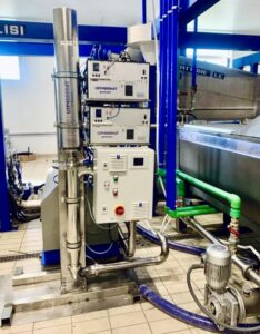 Industrial ultrasonic homogenizer UIP4000hdT with flow cells - installation for high-throughput production. Ultrasonic flow cells for inline processing facilitate the up-scale to large throughput significantly.